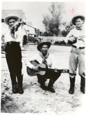 Dave Brubeck playing guitar with two unidentified friends on violin and mandolin (Ione, California)