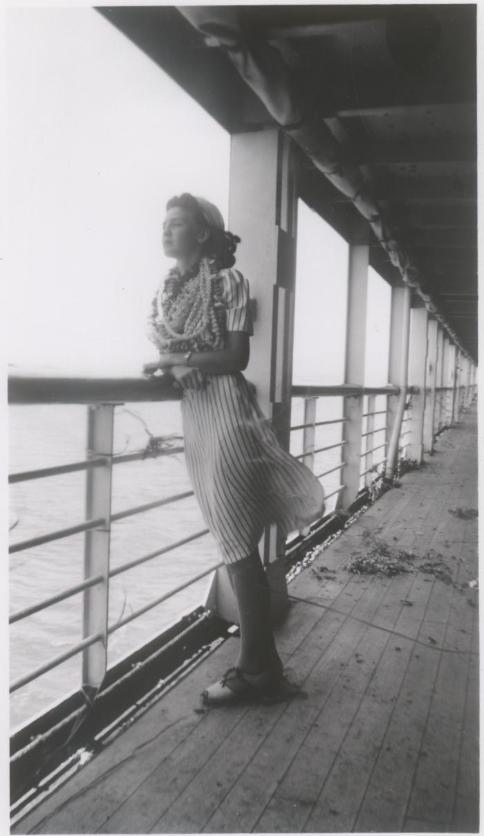 Iola standing at ship's railing