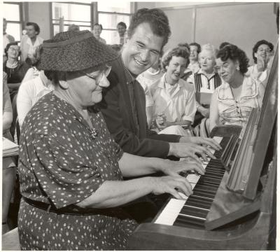 Dave Brubeck and unidentified participant at the piano during a "Dave teaches teachers" session for Alameda County school teachers (California)