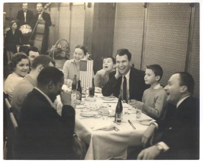 Dave Brubeck, Iola Brubeck, Darius Brubeck, Michael Brubeck, Roman Waschko, Eugene Wright, Joe Morello and unidentified others dining (Poland)