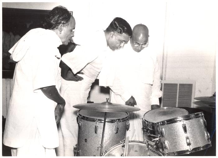 Indian percussionists inspecting Joe Morello's drum kit (Madras, India)