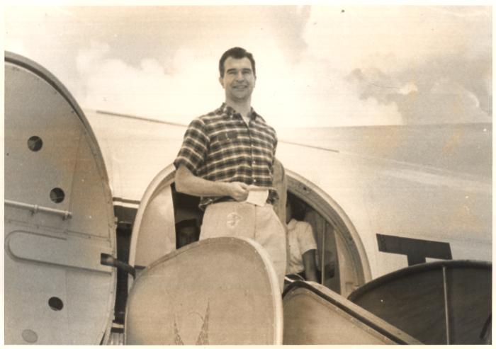 Dave Brubeck standing in front of the open hatch of an airplane (India)