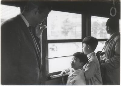 Dave Brubeck talking with children on a train (Tokyo, Japan)