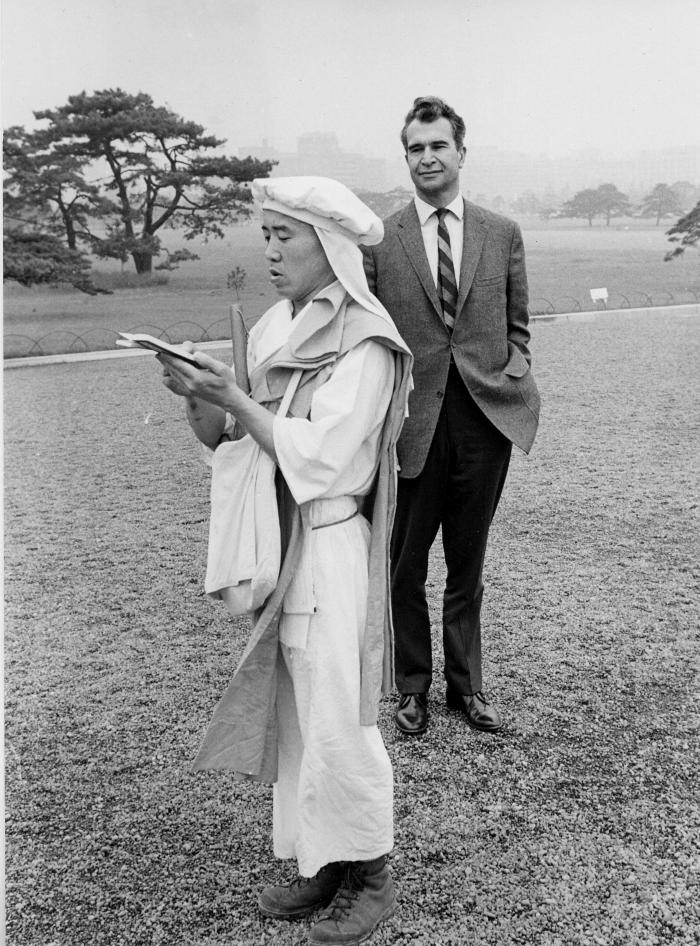 Dave Brubeck observing traditionally clothed person [Shinto chanter?] (Tokyo, Japan)