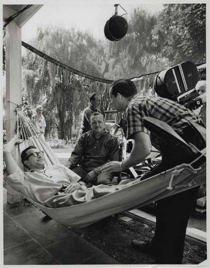 Dave Brubeck (in hammock), Walter Cronkite, and crew members during filming of an episode of the CBS television show "The 20th Century" at Dave Brubeck' home (Wilton, Connecticut)