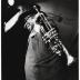 Louis Armstrong with top hat and trumpet at rehearsal or performance of "The Real Ambassadors" (Monterey Jazz Festival, Monterey, California)