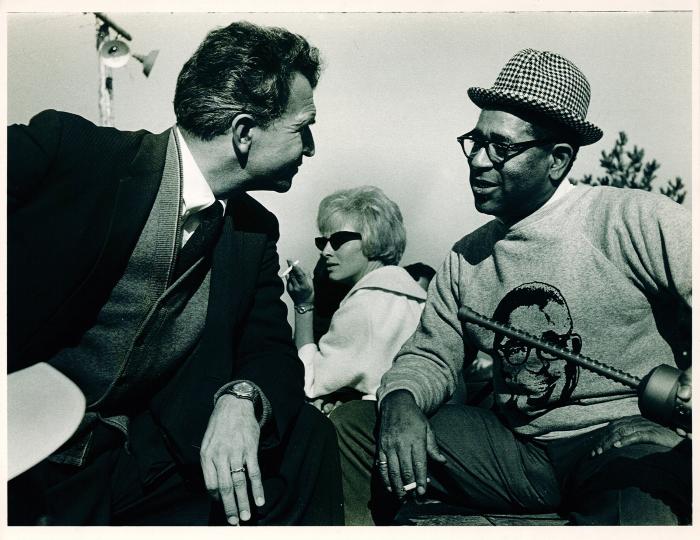 Dave Brubeck and Dizzy Gillespie in conversation,unidentified woman in background (Monterey Jazz Festival, Monterey, California)