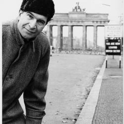 Dave Brubeck wearing an overcoat, hat, and gloves at the Brandenburg Gate (Berlin Wall, Berlin, West Germany)