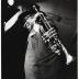 Louis Armstrong with top hat and trumpet at rehearsal or performance of "The Real Ambassadors" (Monterey Jazz Festival, Monterey, California)