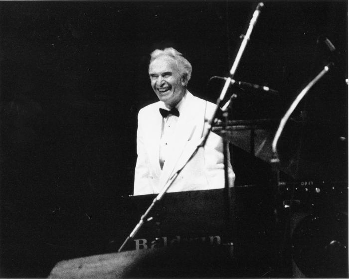 Dave Brubeck at piano in white tuxedo